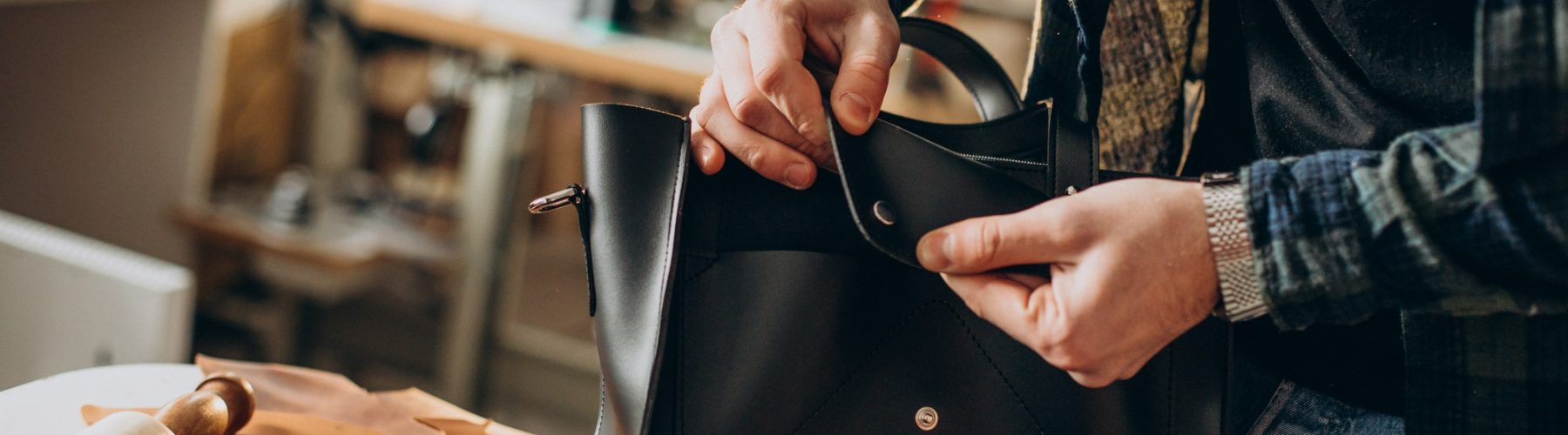 male-designer-leather-tailor-working-factory-close-up